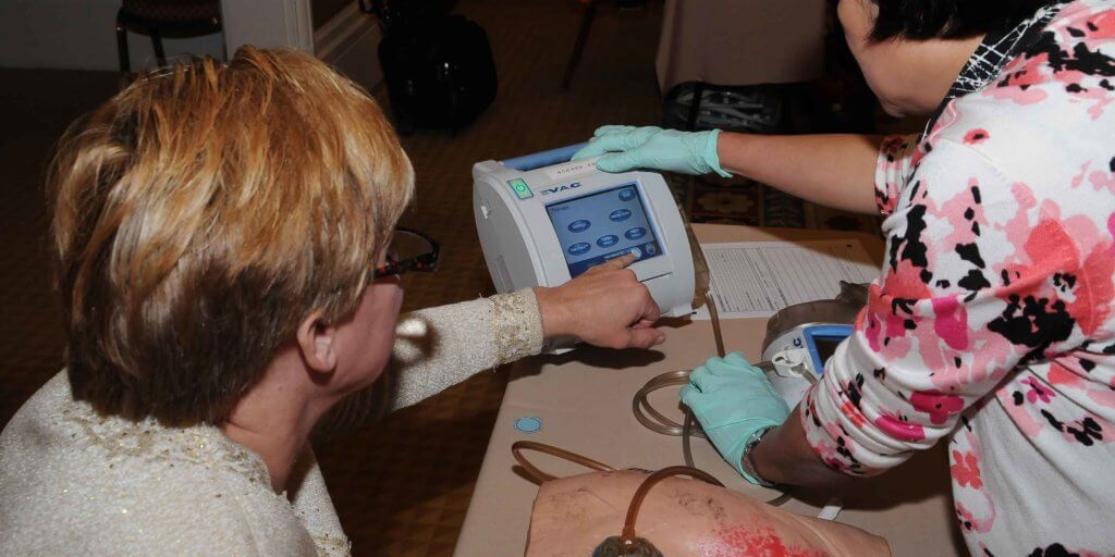 Clinicians try a negative pressure wound therapy device at our Wild on Wounds conference.