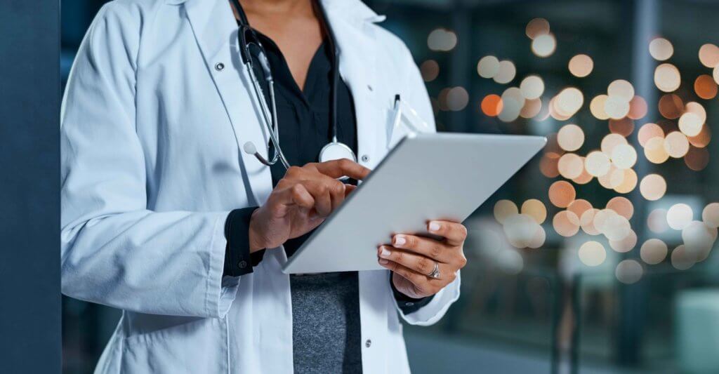 A doctor uses a wound care app on a tablet at the hospital
