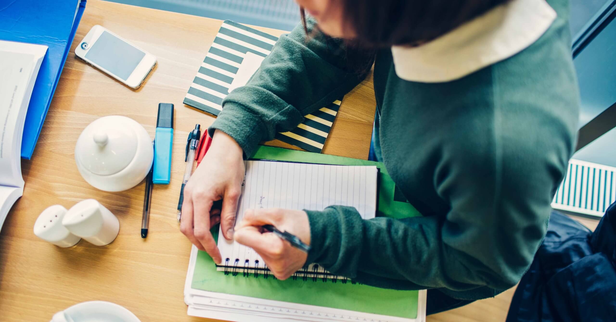 woman writing in notebook