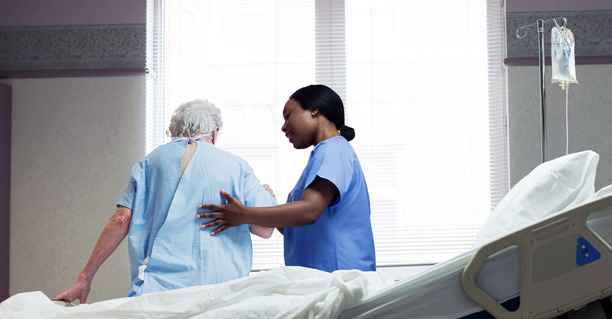 Nursing helping a patient stand up