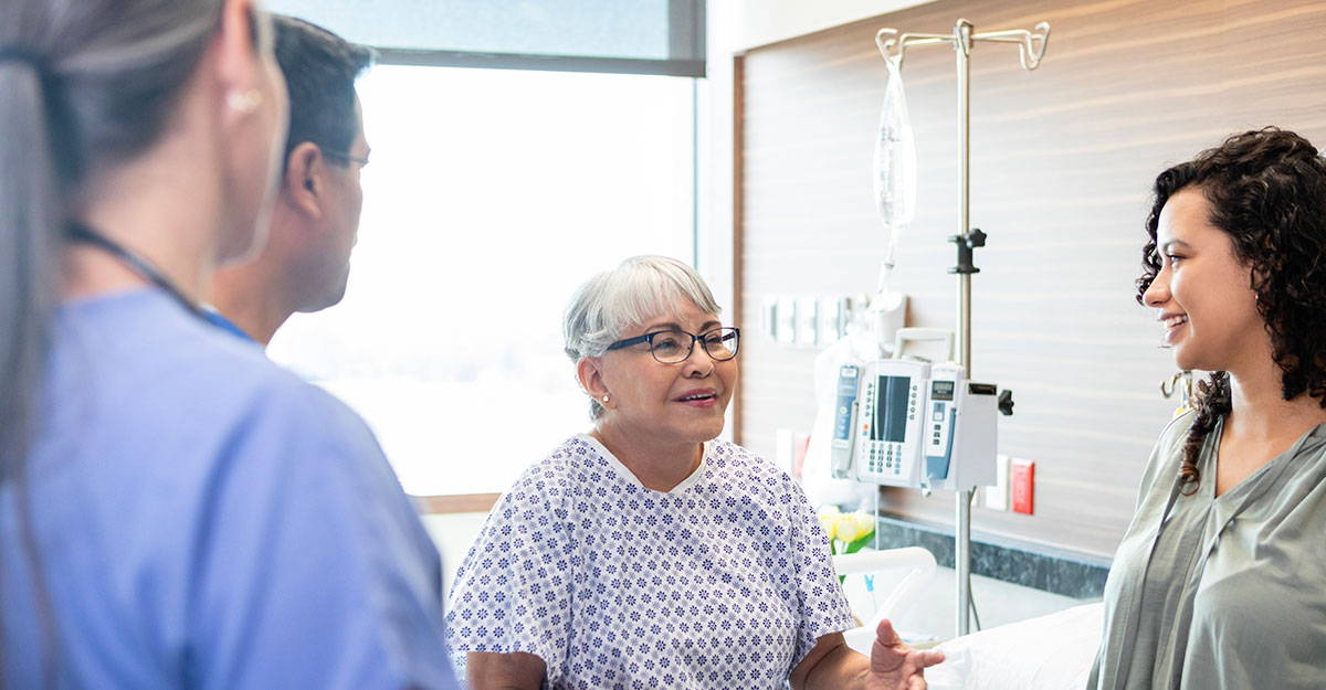 Patient and family member speaking to nurses