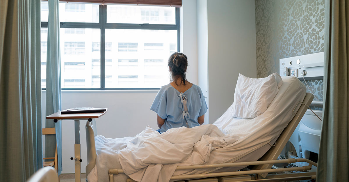 Female patient sitting on hospital bed