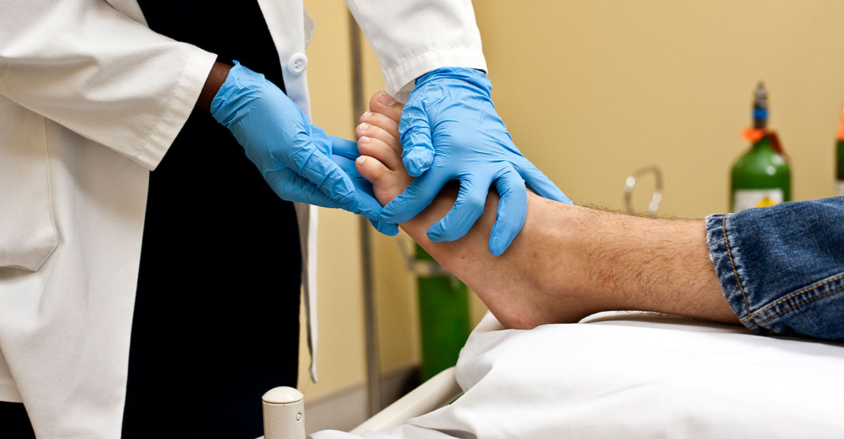 Clinician performing foot exam, using wound description terms