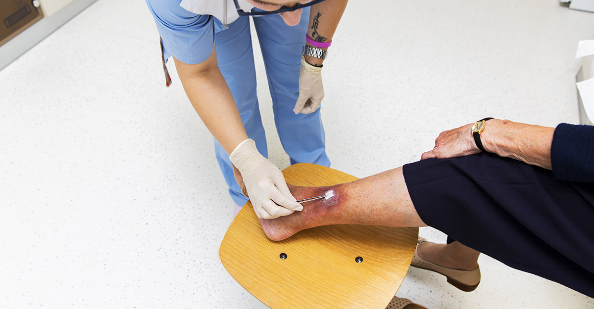 Cute Nurse with tatoo on her forearm is changing bandage